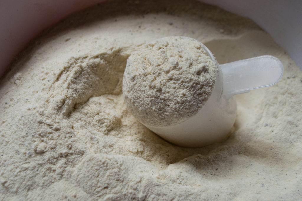 Picture of protein powder with a scoop.